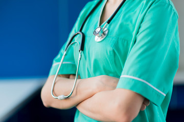 Close-up nurse with stethoscope and crossed arms