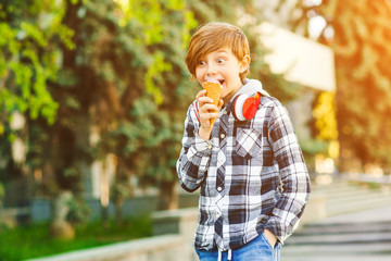 Happy boy eating ice cream outdoors. Summer vacation.