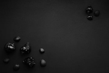 Trendy minimalistic matte black background with shells.