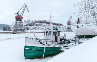 Vintage tug boat is moored in Turku at snowy winter day