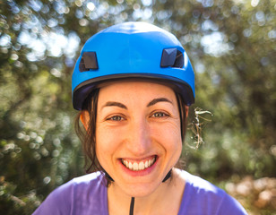 Portrait of a woman in a blue safety helmet.