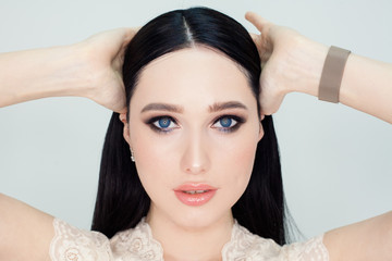 Fototapeta premium A clean face with young skin, a portrait of a woman on a white background. Concept photo for advertising facial cleansing products and creams with a lifting effect.