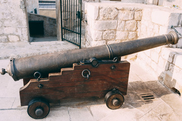 An ancient cannon with kernels on the wall of the old city of Dubrovnik