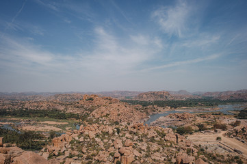 Fototapeta na wymiar Hills of huge stones and valleys of the Tungabhadra River in Hampi
