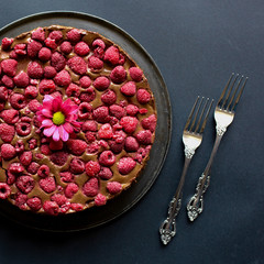 Fruity raspberry chocolate cake and two stylish vintage forks on the side