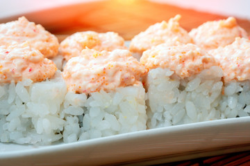 Sushi on white plate close-up, macro cream cheese, sesame. Japan restaurant menu