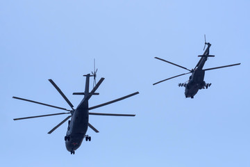 Russian military helicopters against the blue sky.