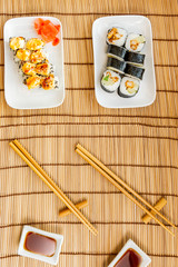 sushi, chopsticks and soy sauce bowl. background with space for your text. Top view flat lay vertical photo