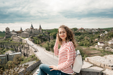 Fototapeta na wymiar Young woman tourist looking on the beauty of the castle