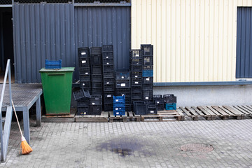 Empty plastic boxes in courtyard of store
