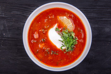 Solyanka with greens and lemon, served hot with bread