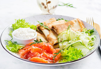 Crepes with salted salmon, cream cheese and salad.
