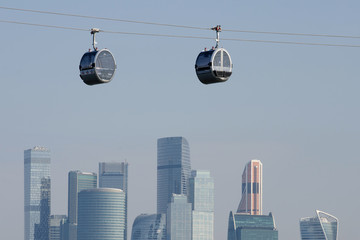 Cable cars above Moscow river and skyscrapers of Moscow city. Moscow, Russia.