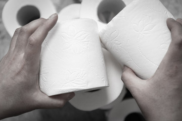 Female hand grabs a roll of toilet paper. Gastrointestinal problem, diarrhea concept.