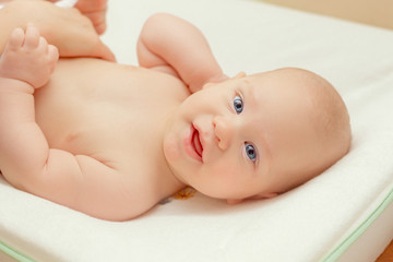 Closeup portrait of beautiful baby boy on the table