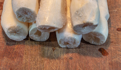 Fototapeta na wymiar Edible manioc root (Manihot esculenta), peeled and frozen on neutral background