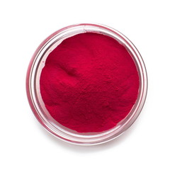 Red powder paint in glass bowl on white background