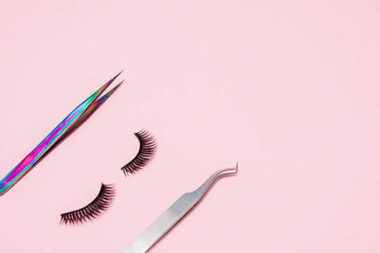 Set for eyelash extension on a pink background. Concept beauty beauty. False eyelashes and tweezers