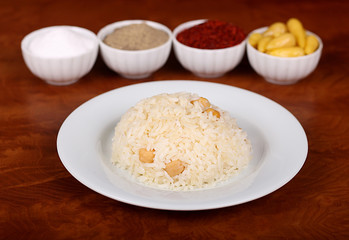 excellent turkish food chickpea rice spicy on white plate on wooden table