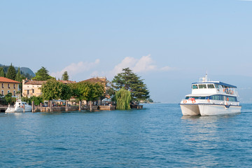 Obraz premium high-speed catamaran operates scheduled trips. Garda lake, Italy