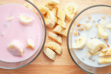Breakfast for health and diet muesli flakes with bananas and milk and yogurt in a bowl.