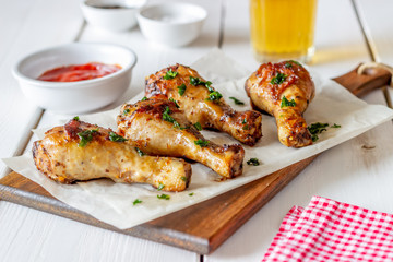 Chicken legs on a wooden background. Barbecue. Grill. American cuisine. Recipe. Rustic.