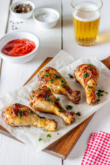 Chicken legs on a wooden background. Barbecue. Grill. American cuisine. Recipe. Rustic.