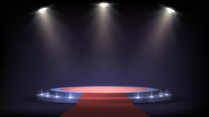 Round stage with steps and spotlights, red carpet on a pedestal