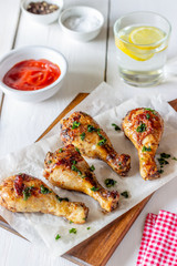 Chicken legs on a wooden background. Barbecue. Grill. American cuisine. Recipe. Rustic.