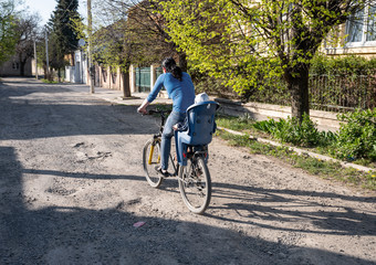 Woman riding bicycle with little son