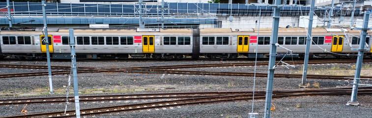 Railway tracks at Brisbane Roma Street with a passing commuter train