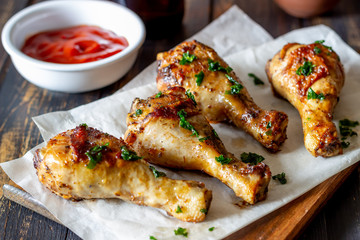 Chicken legs on a wooden background. Barbecue. Grill. American cuisine. Recipe. Rustic.