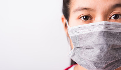 closeup woman wearing face mask protective against coronavirus or COVID-19 virus
