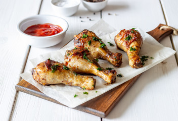 Chicken legs on a wooden background. Barbecue. Grill. American cuisine. Recipe. Rustic.