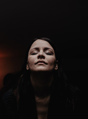 Portrait of a young woman meditating at home