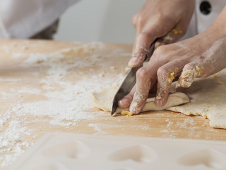 Asian chef preparing dough for pizza or bread on table, work lifestyle