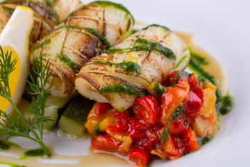 Grilled squid with stewed vegetables and greens