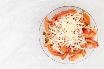 Tomato salad with young onions and cheese. Copy space above white background