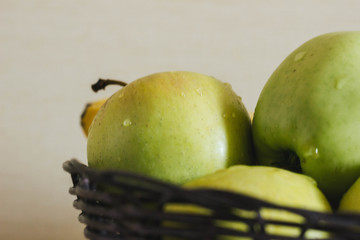 green apples in basket on the table