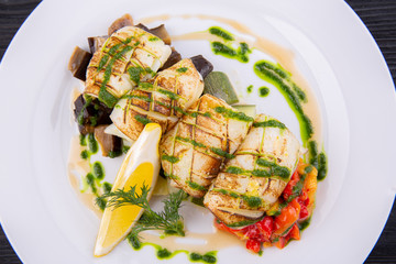 Grilled squid with stewed vegetables and greens