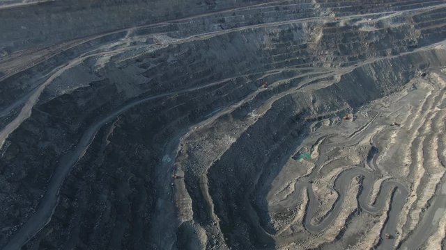 aerial view of asbestos quarry, silicate minerals mining. Dump truck in the asbestos quarry. drone flight above opencast mining quarry with lots of machinery at work, environment and ecology concept