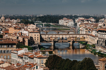 Fototapeta na wymiar A bridge in Florence, located at the narrowest point of the Arno River. Daytime landscape in Italy.