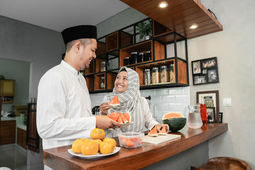 muslim couple preparing for breaking the fast on ramadan month
