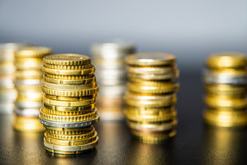 Stacks of euro coins on black table