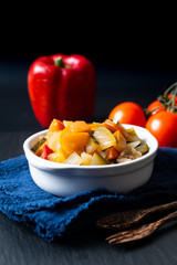Food concept Homemade French organic Ratatouille in white bake ceramic bowl on blask slate stone board © TYSB