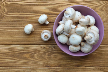 Fresh mushrooms on a wooden table, top view