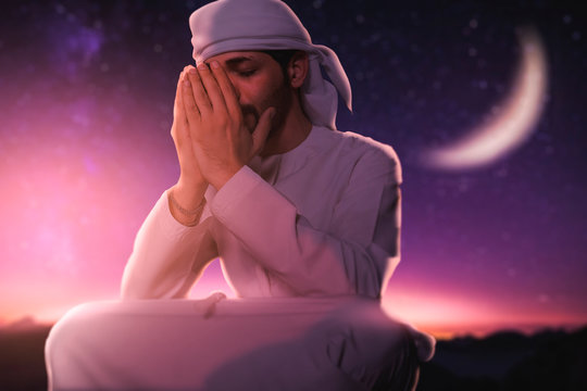 Arabic man doing Duaa in the middle of desert. Arab man asking god for mercy, Ramadan holy month for muslim people.