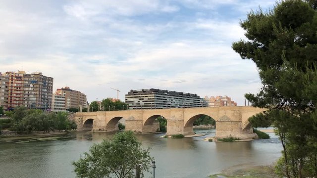 The Ebro river and the old Stone Bridge of Zaragoza in Spain, in a cloudy day