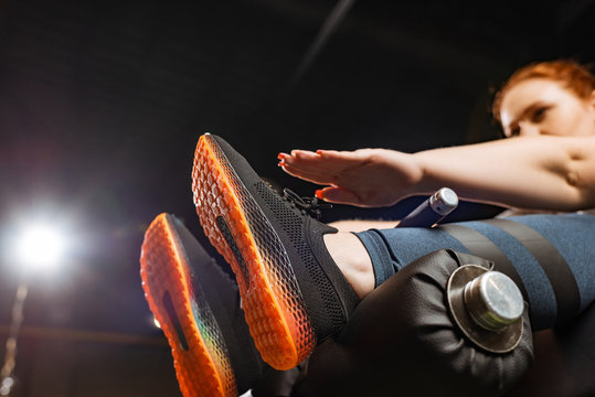 Low Angle View Of Overweight Girl Doing Abs Exercise On Fitness Machine