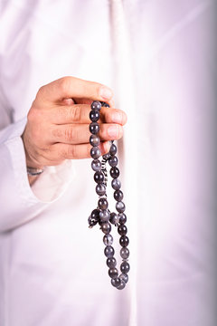 Arabic man hand holding a muslim rosary. ramadan holy month, .Ramadhan kareem concept.